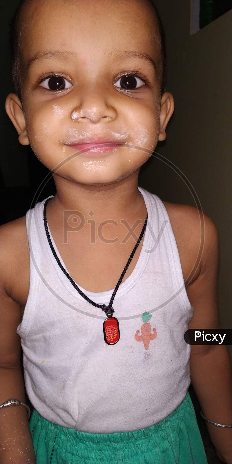 Image of a little  boy with some flour on face