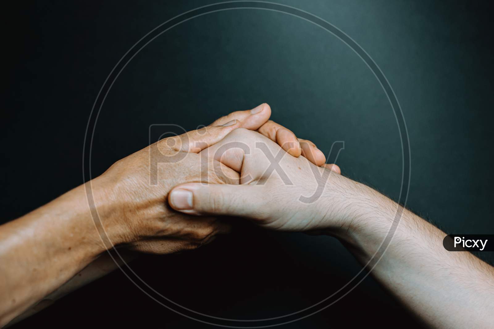Two Old Hands Grabbing Young Hands