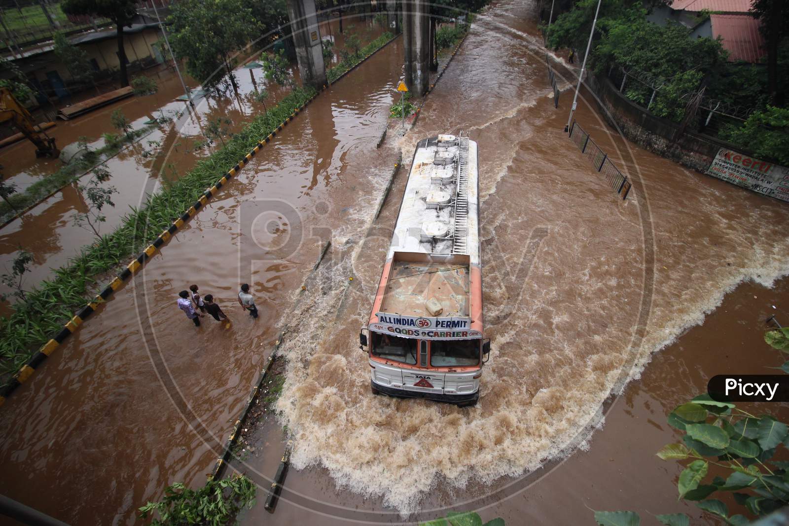 A vehicle passes through a waterlogged road during rains, in Mumbai, India on August 4, 2020.
