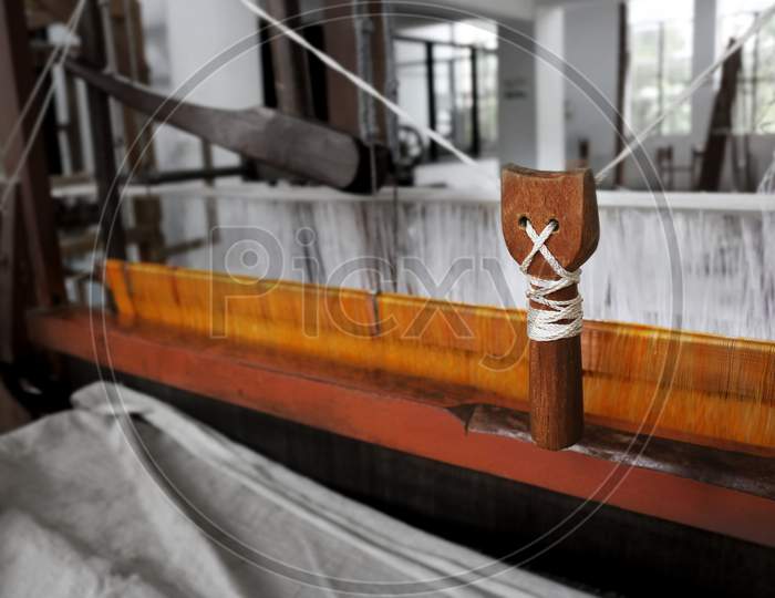'Picker' a handloom  mechanism used to through the shuttle with weft yarn to weave a fabric.