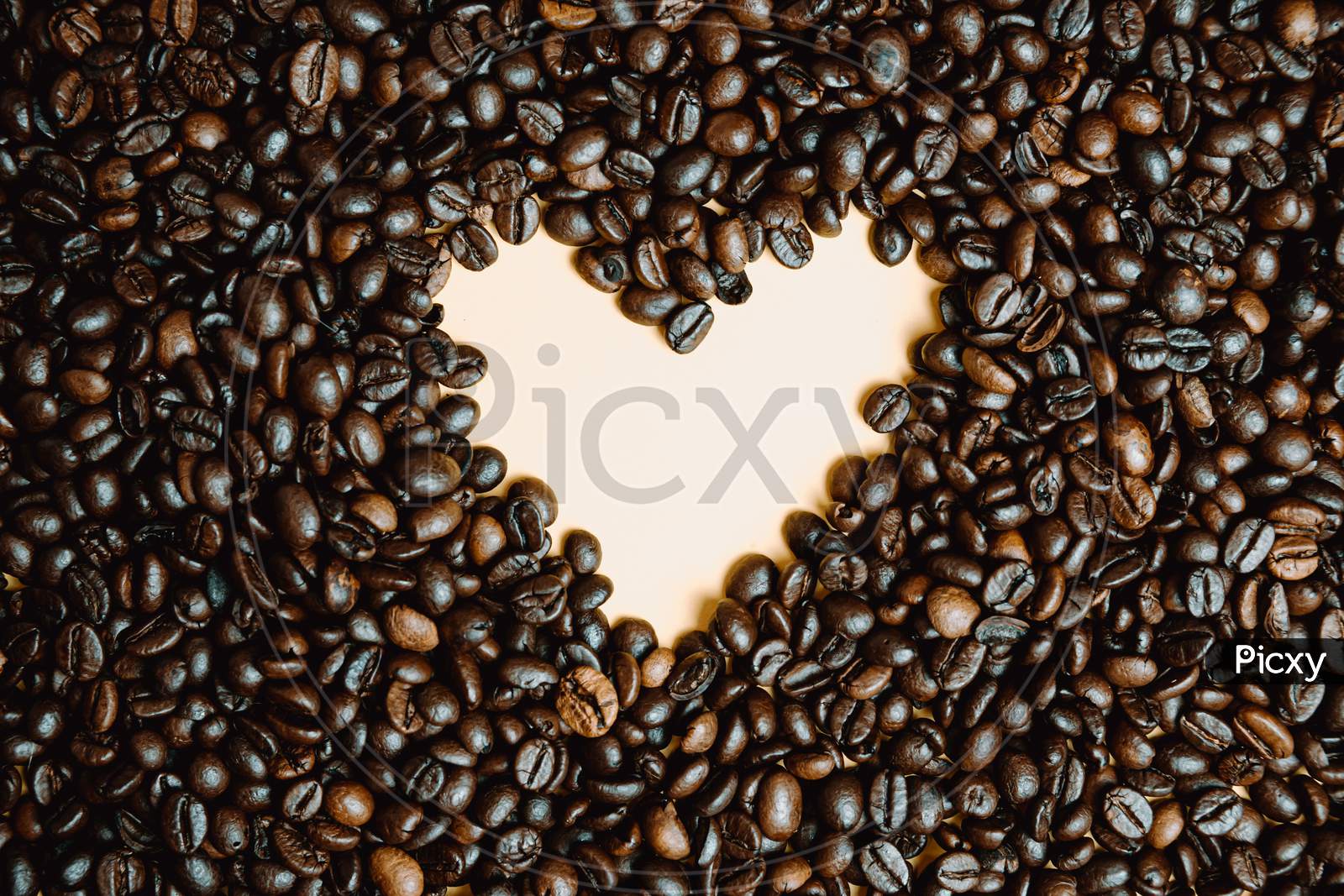 Yellow Heart Draw Inside A Lot Of Coffee Grains