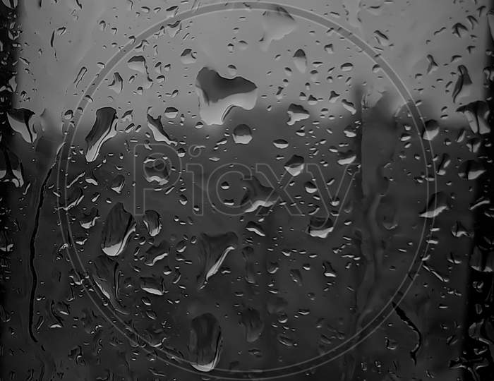 first rain water drops on window glass