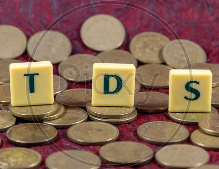 Tax Deducted at Source or TDS word design with Indian five rupee coin for various type of financial transaction or stock market option
