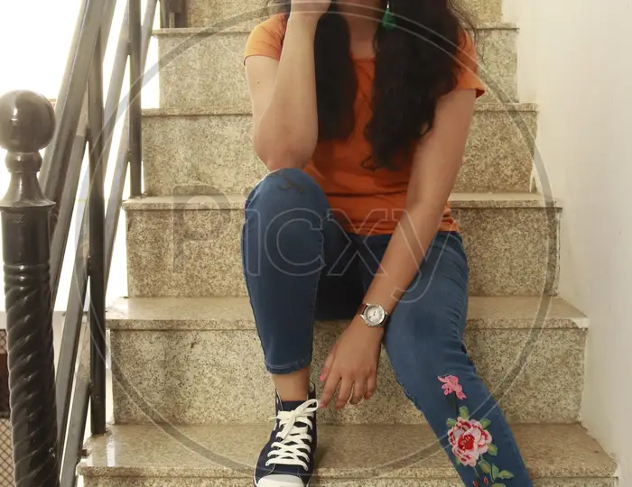 Image of Indian woman wearing pink top and bell bottom jeans-PX290974-Picxy