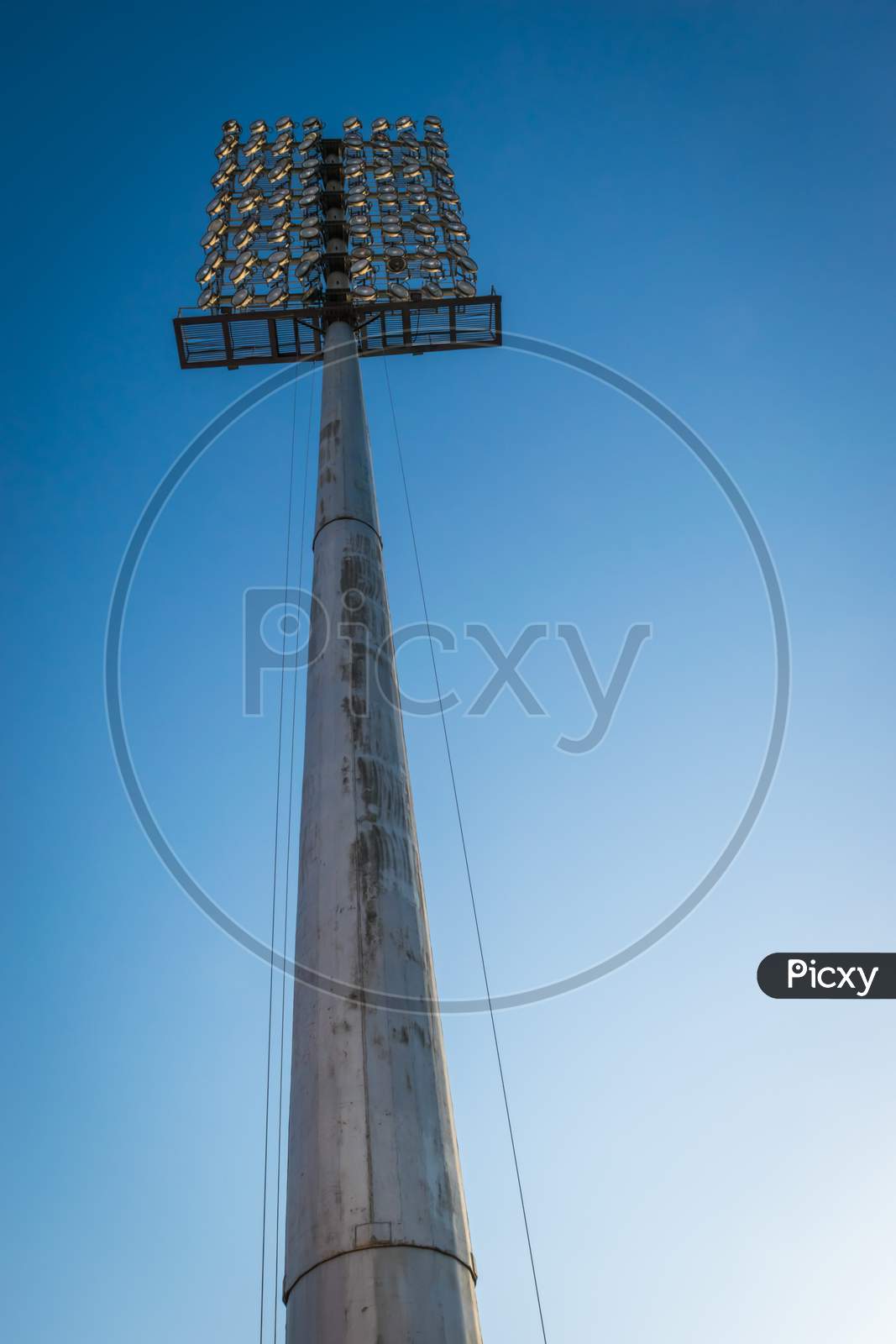 High Angle Of Ground Sports Light With Blue Sky Background