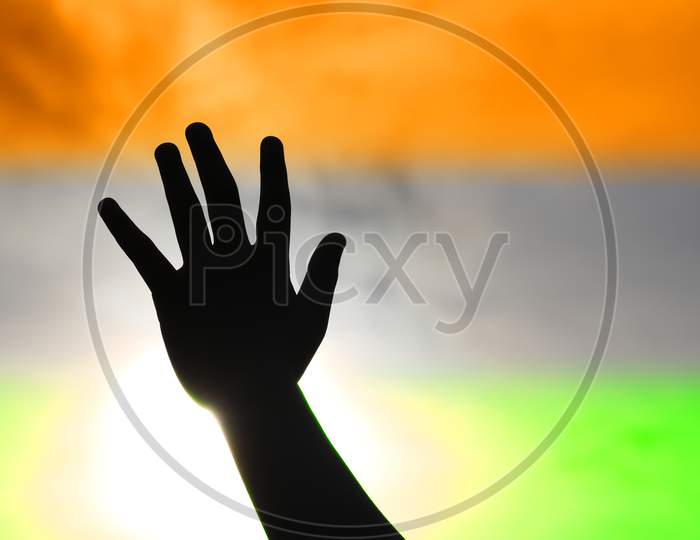 Hand reaching out to the sky celebrating the Independence of India