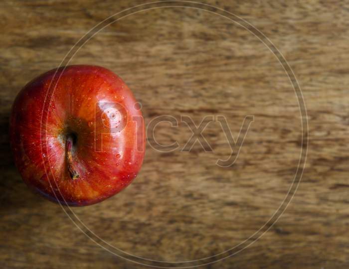 Apple top view in a wooden background with copy space