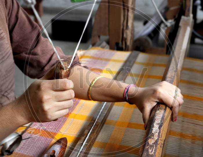 Handloom weaver in India working in her loom