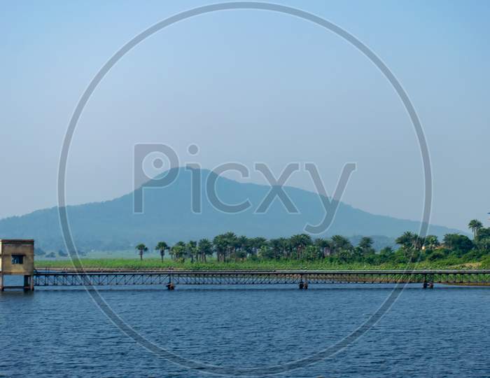 A beautiful landscape in baranti purulia westbengal India surrounded blue river like big lake with small hill top area