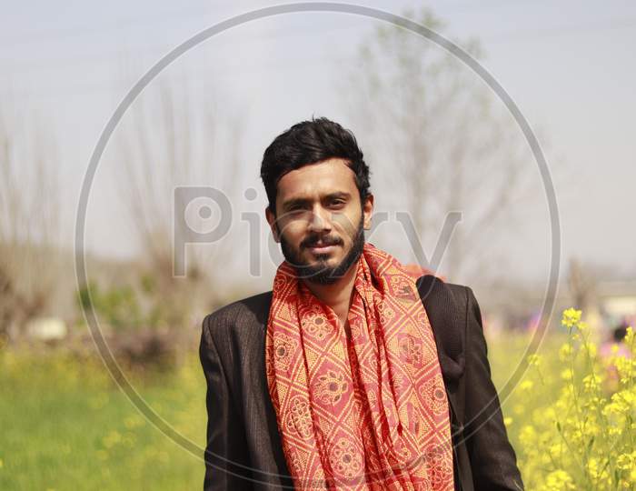 Indian Man in wedding suit in the farm
