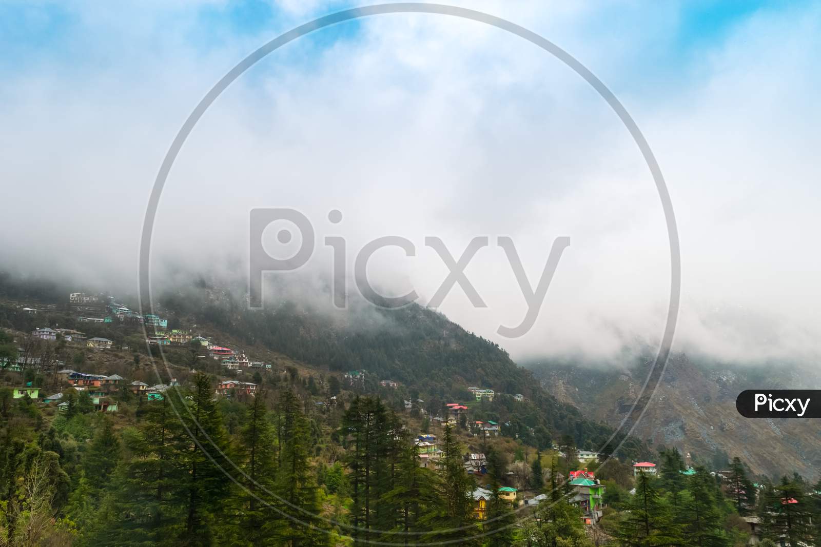 From The Hotel'S Balcony, Huge Clouds Cover The Himalayan Mountains And The Blue Sky At Dharamsala In Himachal Pradesh.