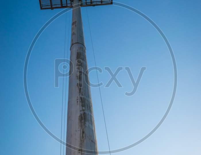 High Angle Of Ground Sports Light With Blue Sky Background