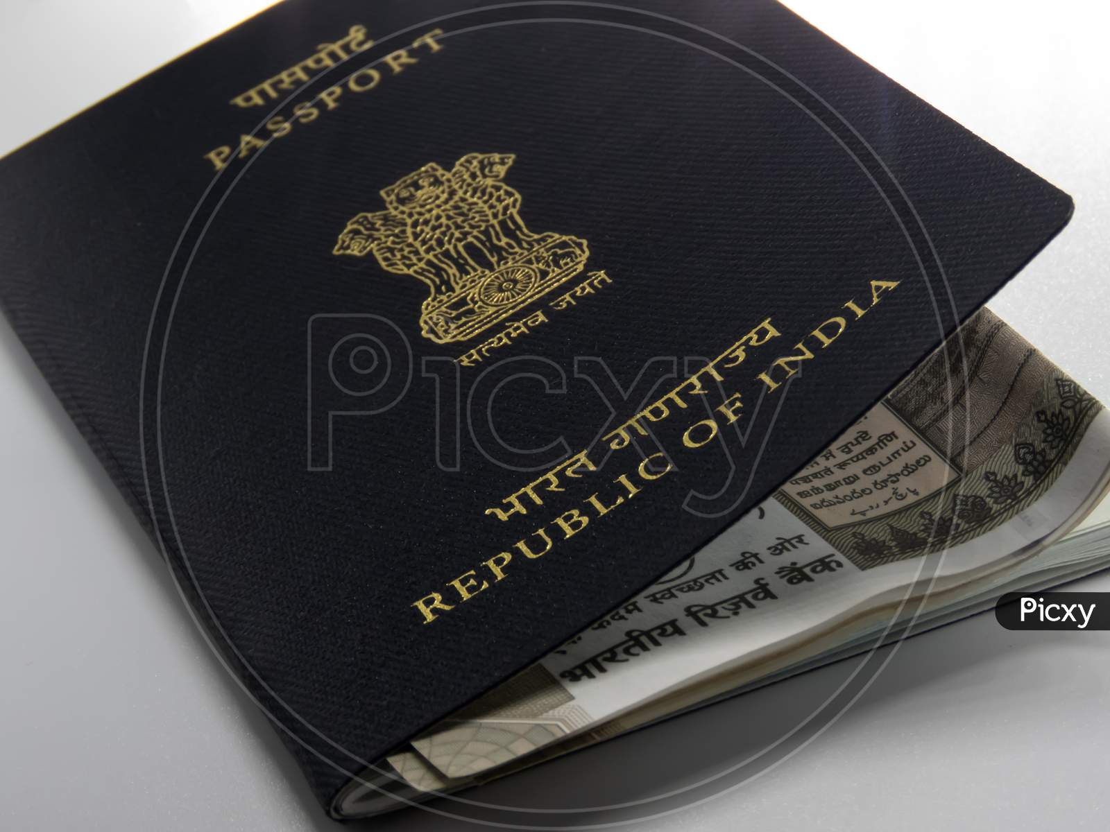 Indian Passport Kept On The Desk Along With Cash.