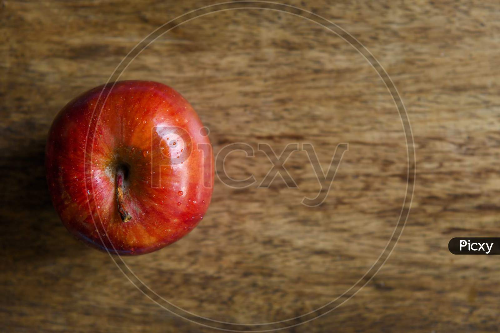 Apple top view in a wooden background with copy space