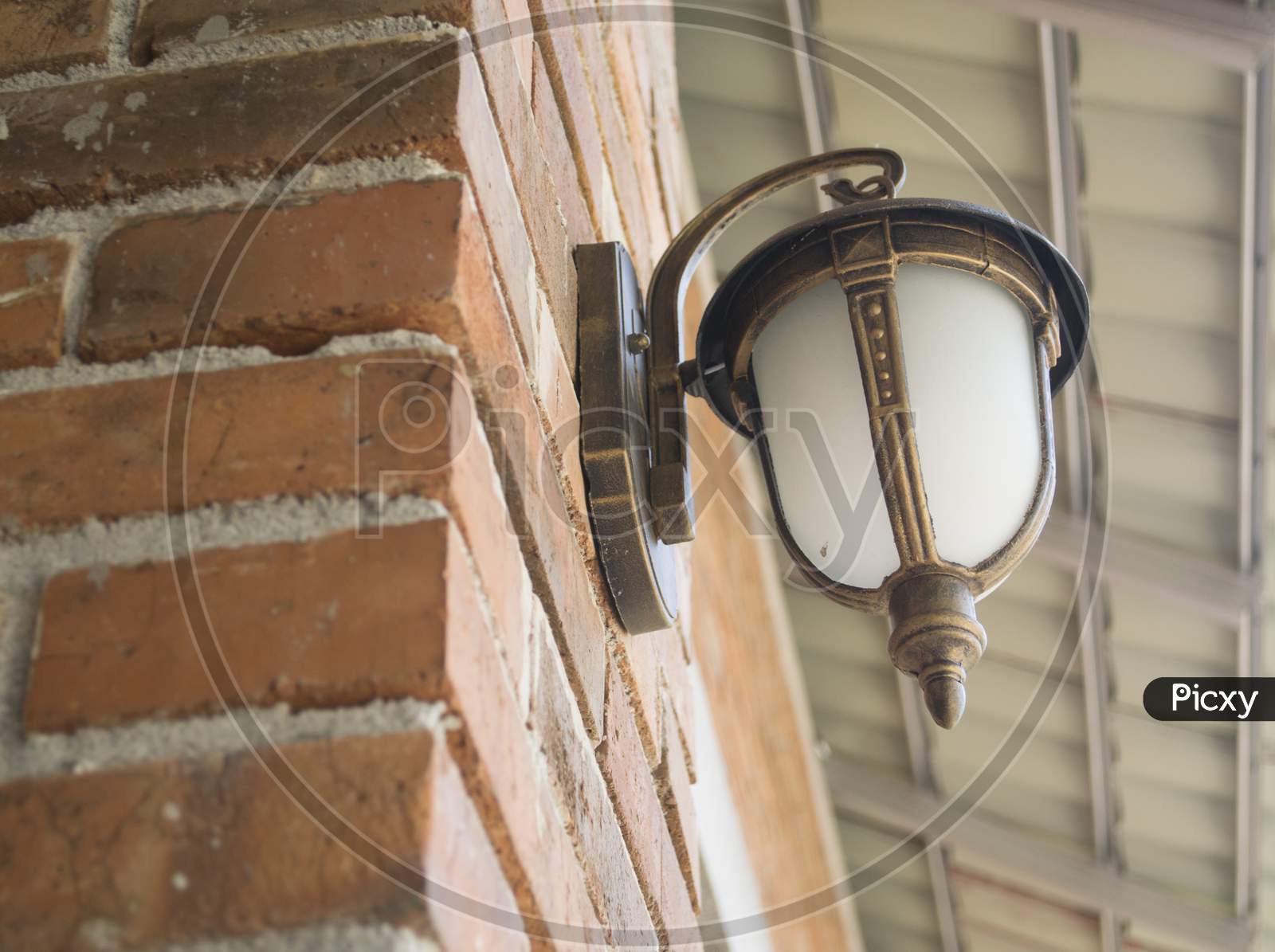 Brown Decorative Electric Lamp Mounted On A Brick Wall