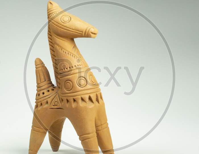 Terracotta miniature horse on white background