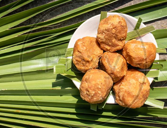 Top View Of Sweet Palm Jaggery In A Plate Isolated On A Palm Leaf