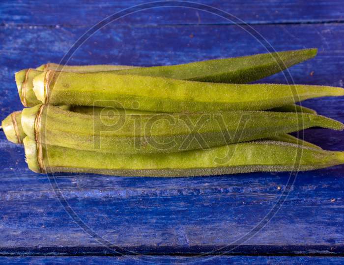 Bhindi Or Lady Finger Vegetable Isolated On Wooden Background