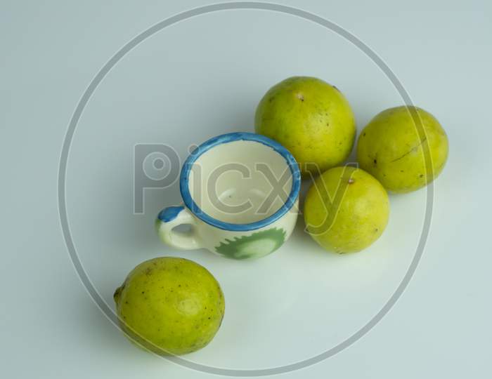 Sliced lemon and lemon juice kept on a mini glass