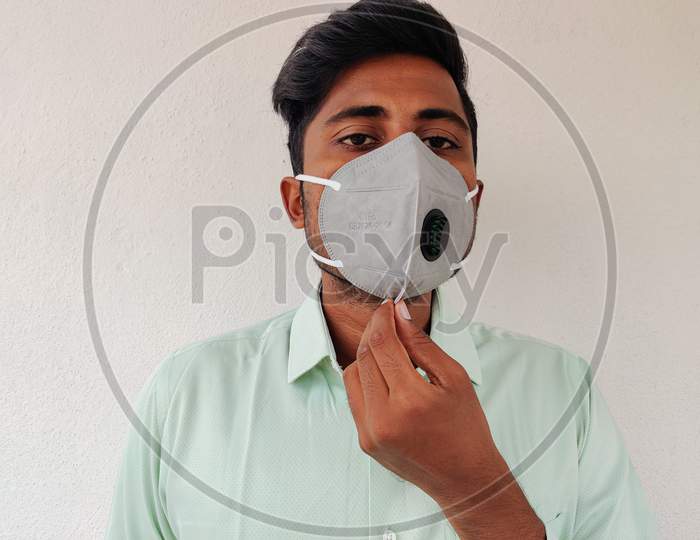 Young Man Wearing Grey Color Kn 95 Face Mask. Green Shirt Guy. Corona Virus Protection.