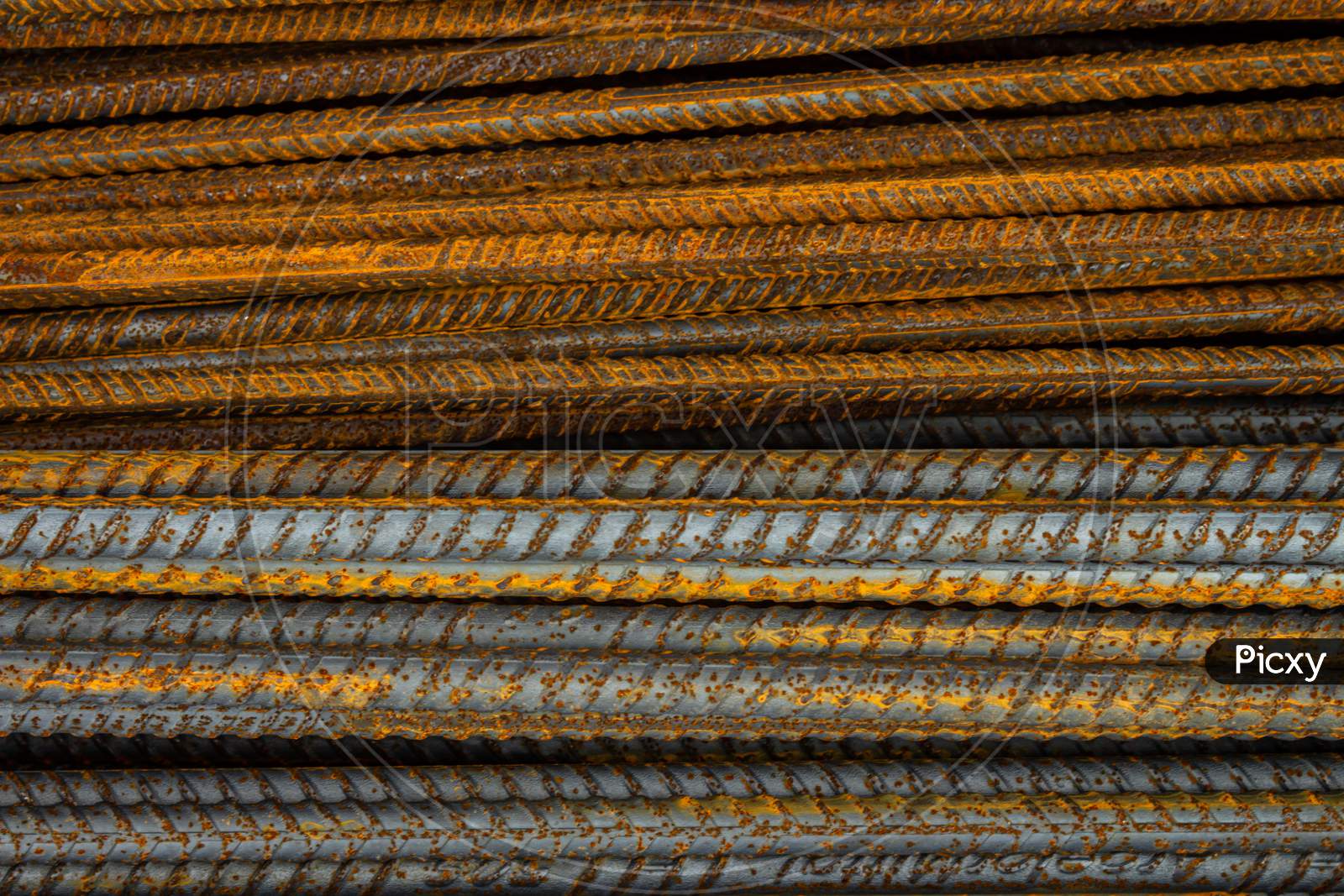 Rusty Steel Rods. Material For The Construction Of Buildings And Houses. Strong Metallic Material Forming A Repeating Pattern