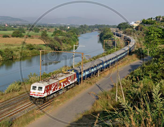 Amul Milk advertised locomotive with Indore express running parallel to a river Indrayani through Kamshet, India.