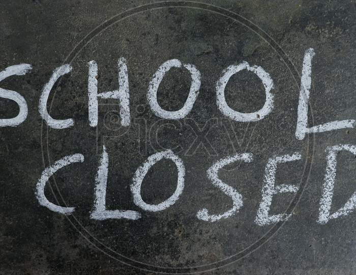 School Closed Phrase Written On Blackboard With White Chalk