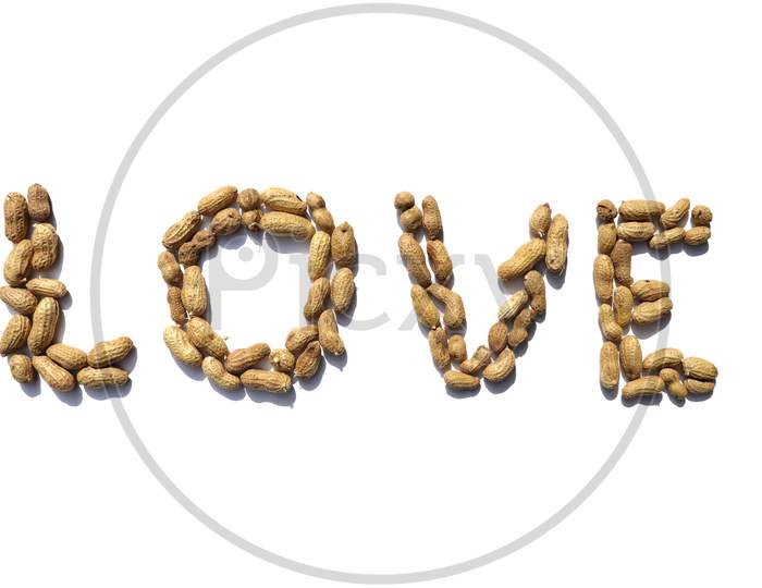 Love Word Written With Peanuts On White Background In Horizontal Orientation, Perfect For Wallpaper