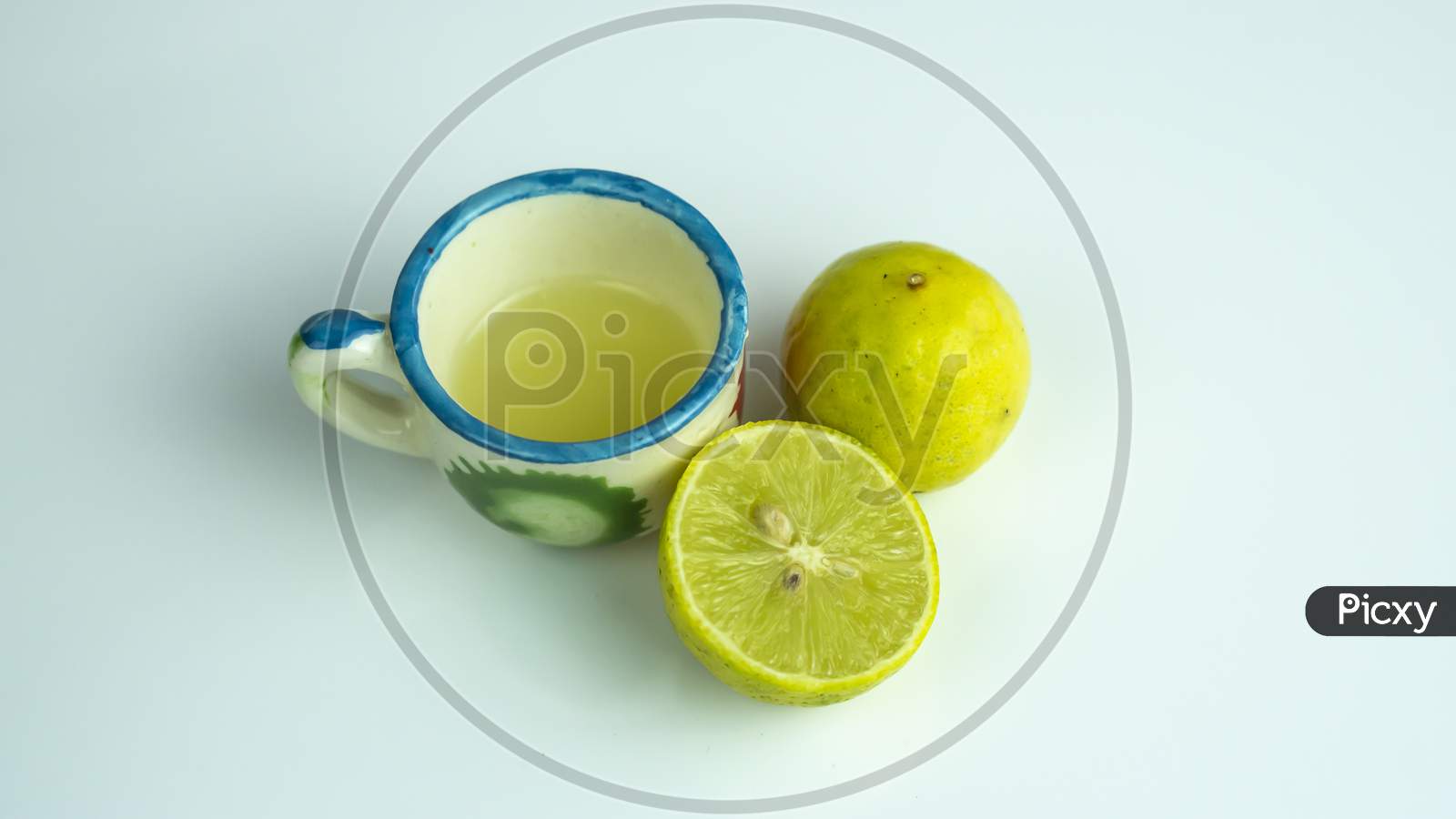 Sliced lemon and lemon juice kept on a mini glass