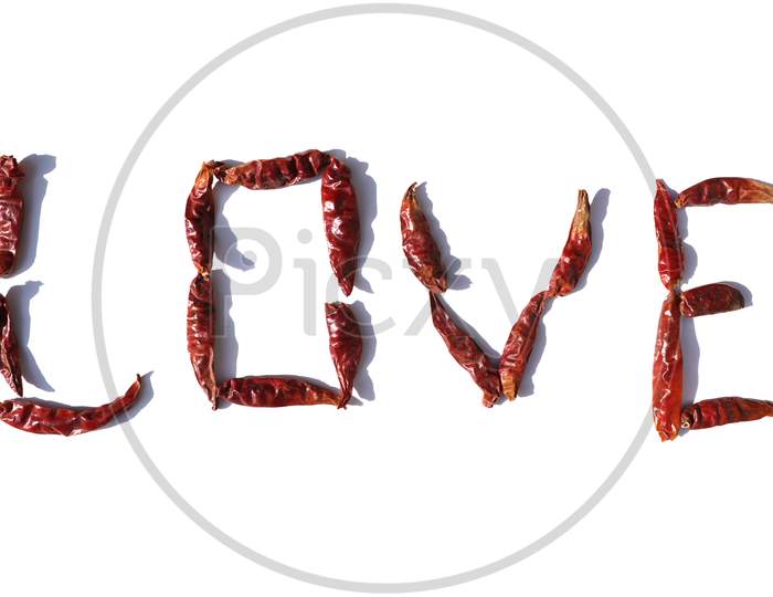 Love Word Written With Red Chillies On White Background