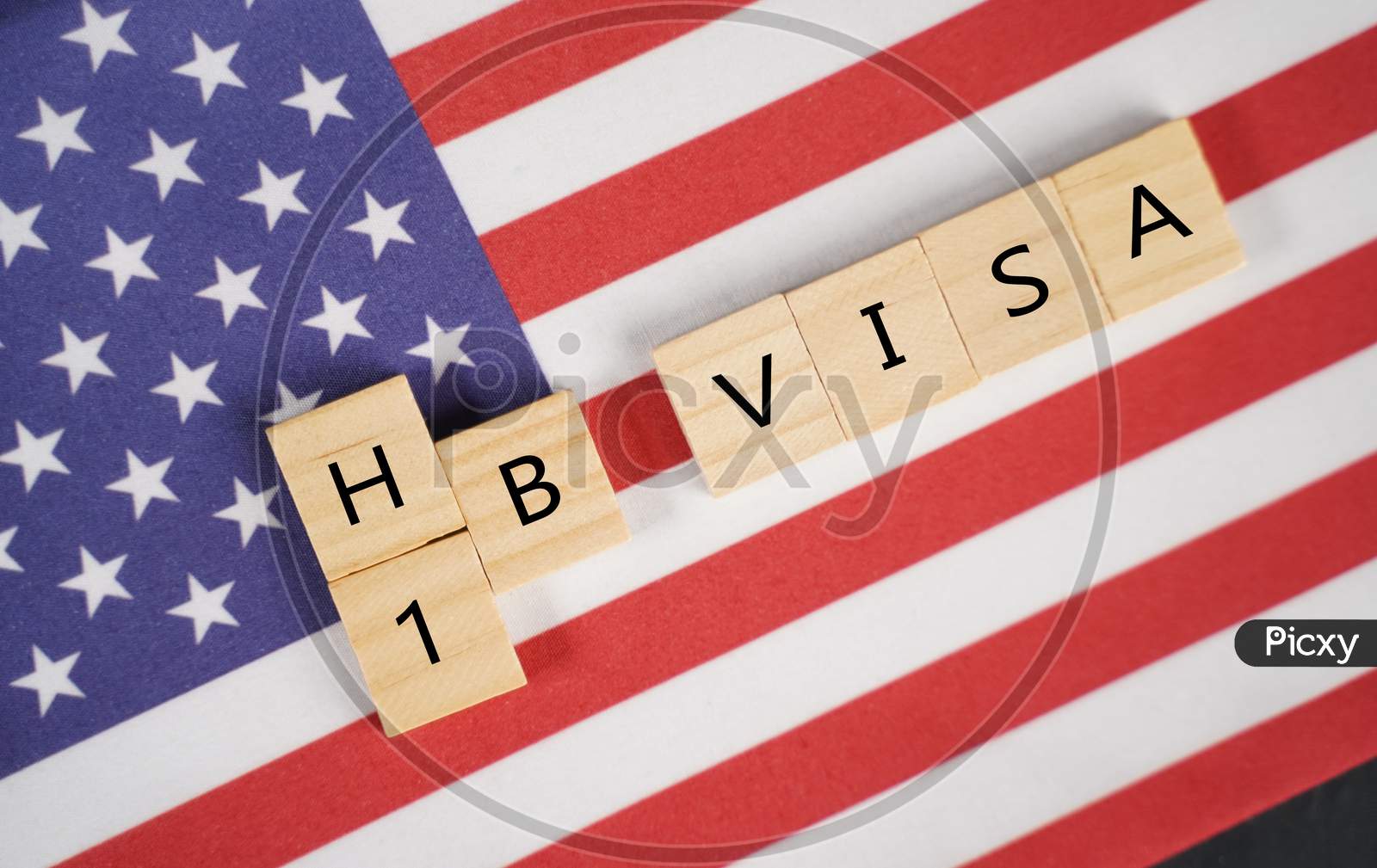 Concept Of H1B Visa For Foreign Workers Showing Wooden Letters With Us Or United States Flag As Background