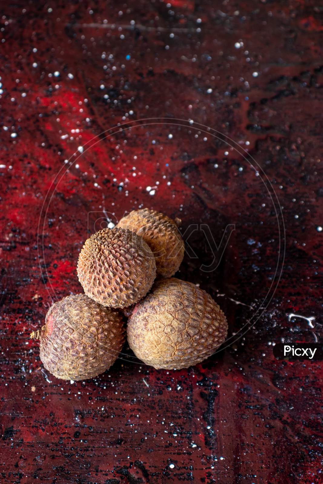 Ripe Lychee Or Lichi Isolated On Reddish Background In Vertical Orientation