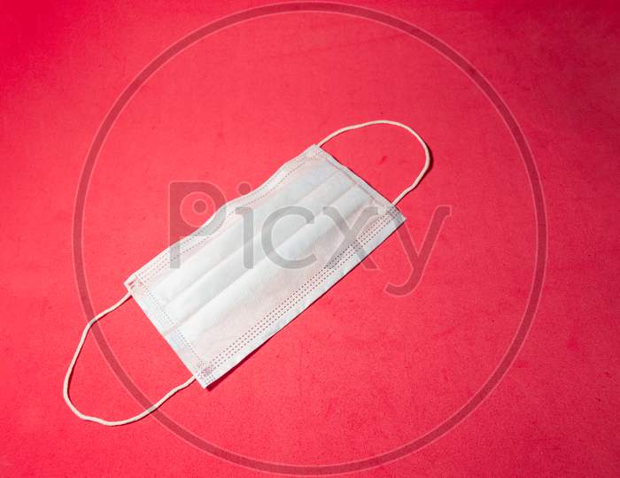 Medical Face Mask On A Red Background