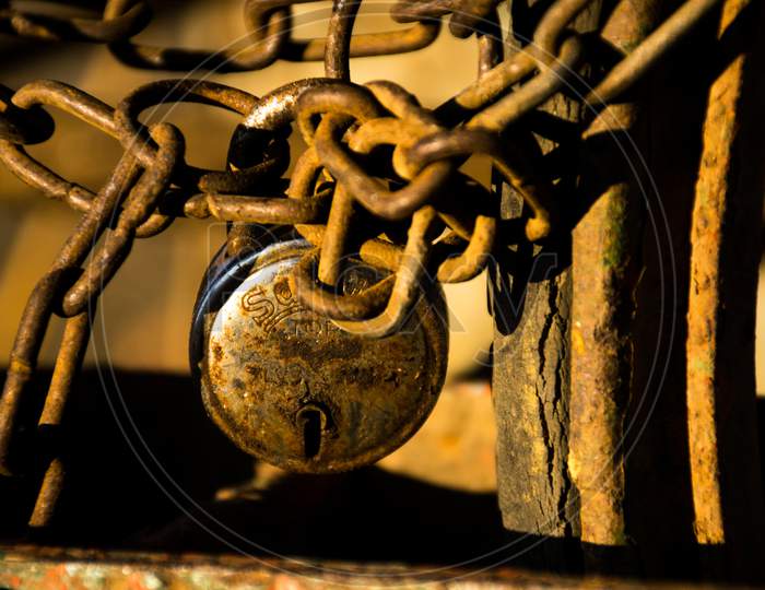 Close-Up Photograph Of A Metal Chain And A Lock