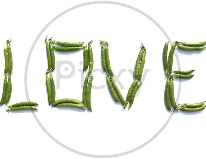 Love Word Written With Green Pea Isolated On White Background, Perfect For Wallpaper