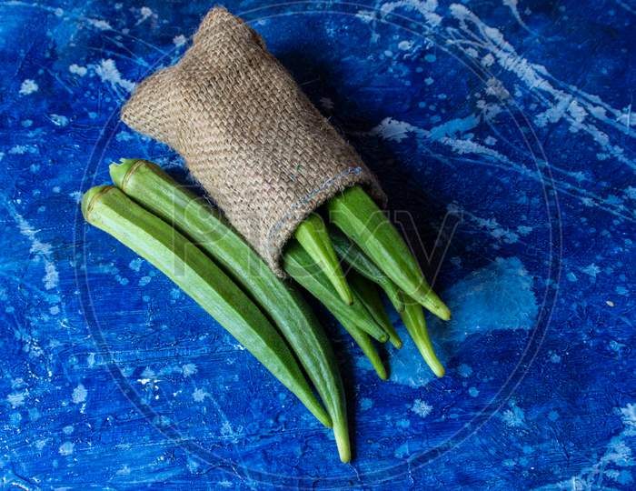 Bhindi Or Lady Finger Vegetable Isolated On Bluish Background