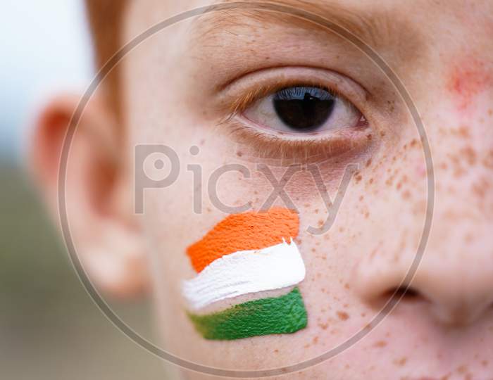 Closeup Of Tricolor Indian Flag Painted On Kid Face During Indian Independence Day - Concept Of Patriotism Or Support For Country