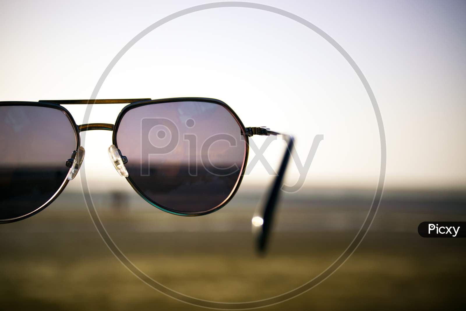 Retro Themed Sunglasses Held In Air At Jampore Beach Of Daman In India