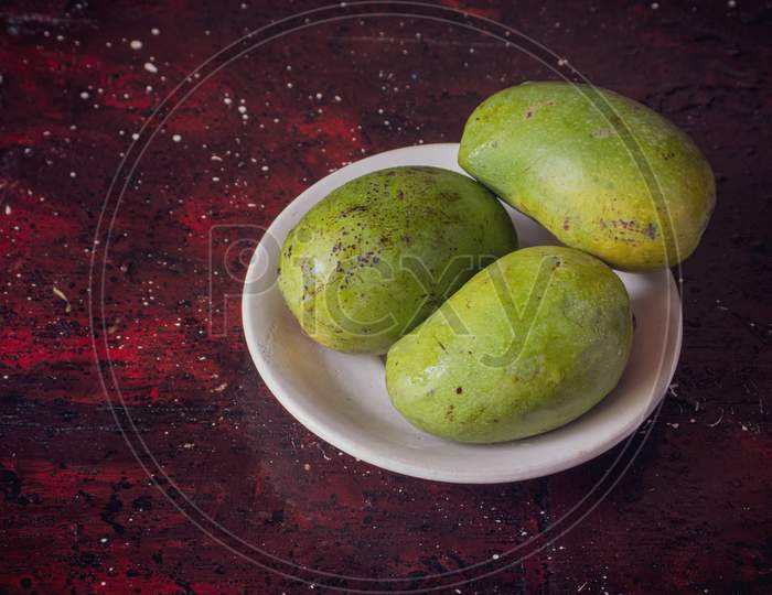Ripe Himsagar Mangoes In A Plate Isolated On Reddish Background With Copy Space