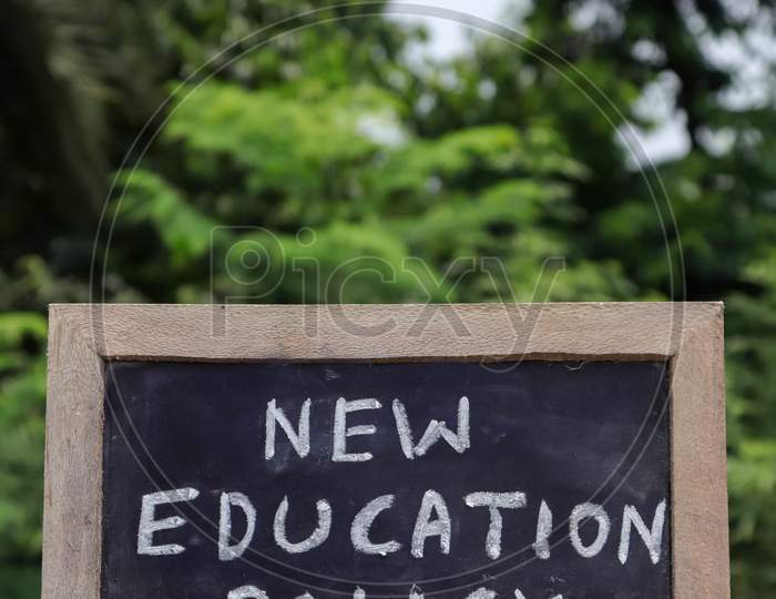 New Education Policy 2020 Written On Chalkboard With White Chalk  In Vertical Orientation