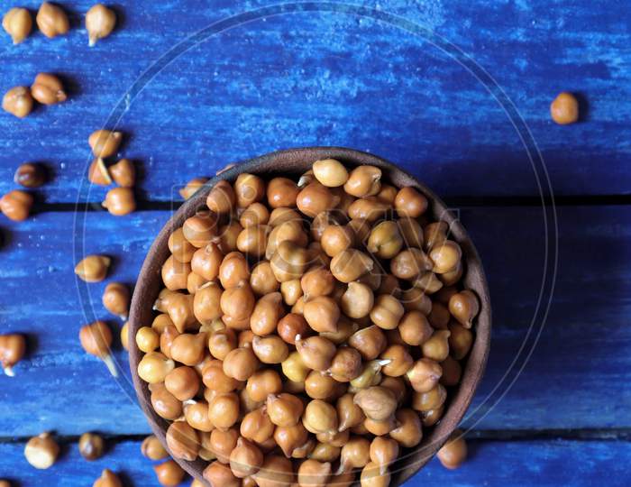 Top View Of Wet Chickpea Or Garbanzo Bean In A Clay Bowl Isolated On Blue Colored Wooden Background