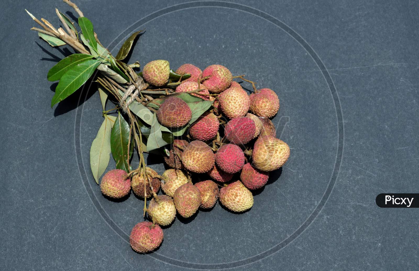 Organic Litchi Or Lychee Cluster With Leaves Isolated On Black Bckground