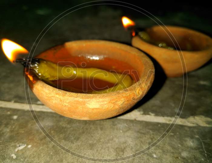 candles lit on the occasion of deepavali, a hindu festival of light with selective focus on candle and background and foreground blur