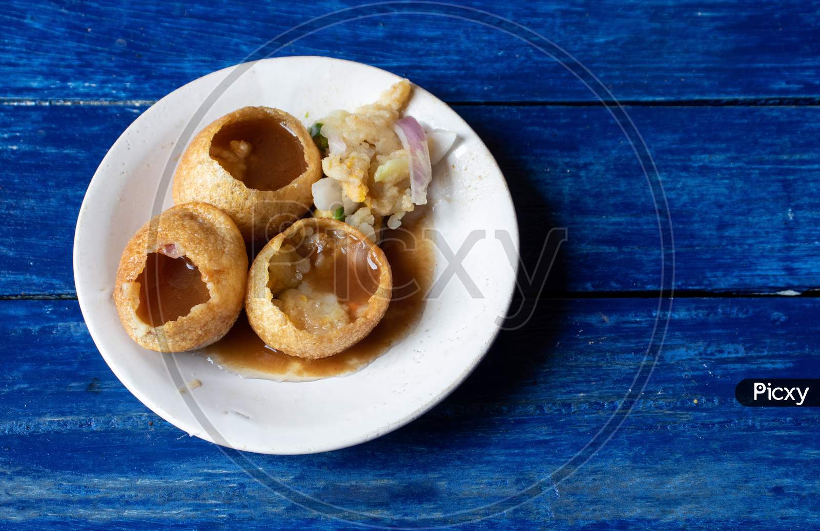 Panipuri Or Golgappa In A Plate Isolated On Blue Wooden Background With Copy Space, Also Known As Phuchka , Paani Patashi, Gol Gappa, Gup Chup