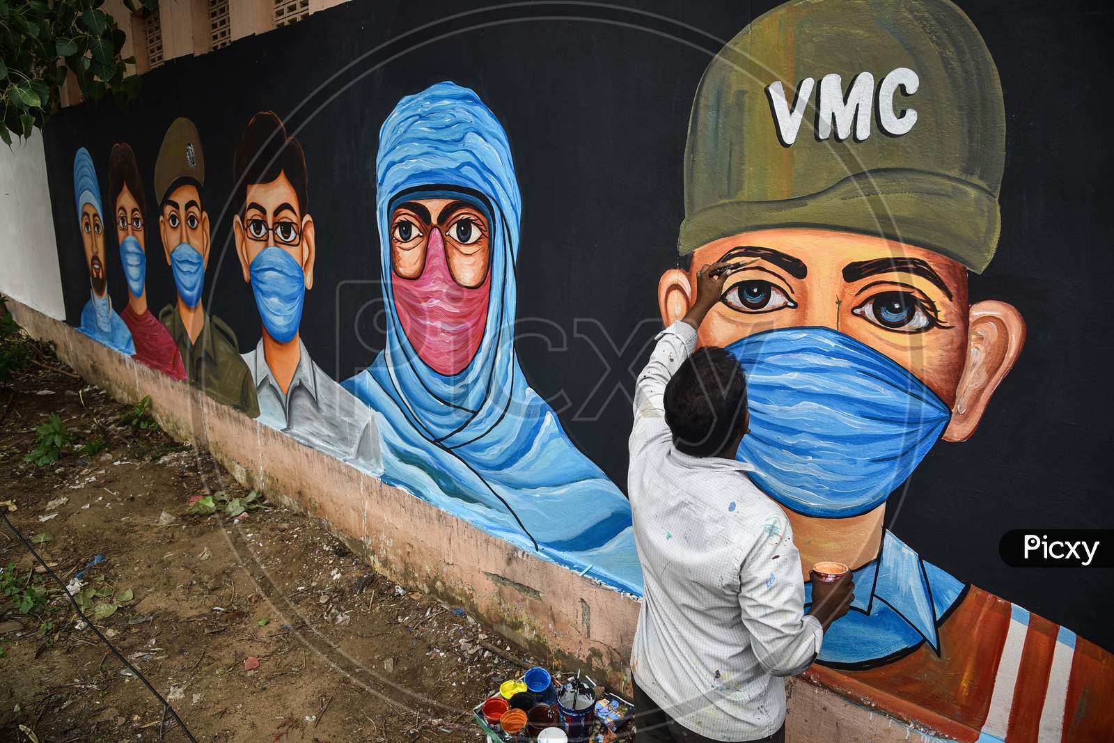 An Artist Paints A Mural On A Wall To Create Awareness On Wearing A Face Mask To Prevent The Spread Of Coronavirus, In Vijayawada, August 05, 2020.