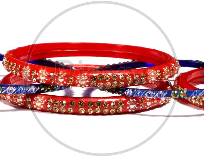 Red And Blue Bracelets Decorated With Colorful Small Stones Isolated On A White Background