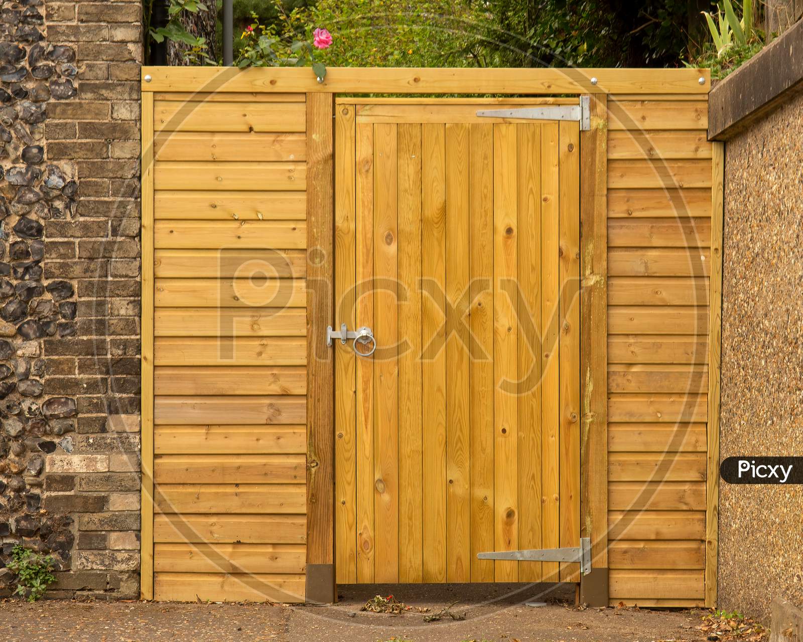 Wooden Garden Gate And Fence Panel With Nobody In View.