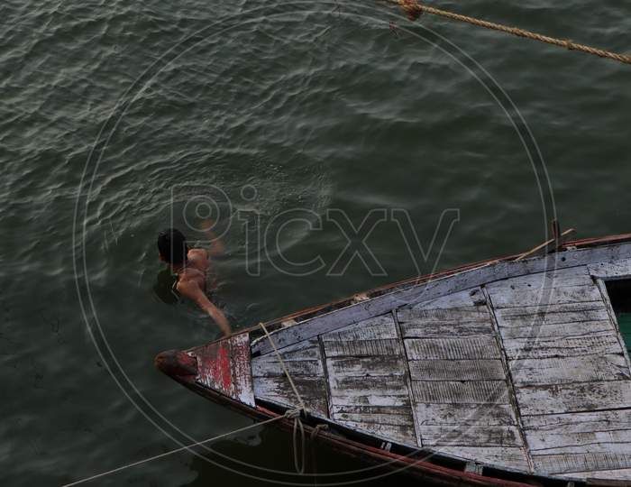 Bokeh shot of boats in the river Ganges with selective focus in Varanasi.