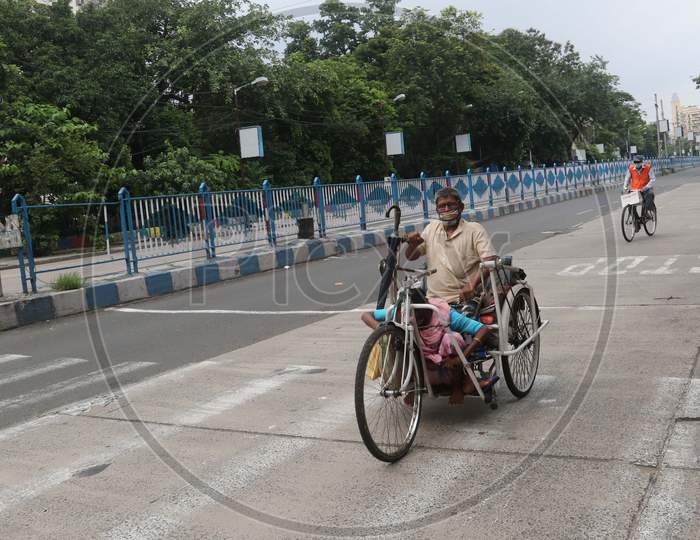 A differently abled man rides on a street that wears a deserted look amid the complete bi-weekly lockdown imposed by the government to curb Coronavirus spread in Kolkata on August 8, 2020