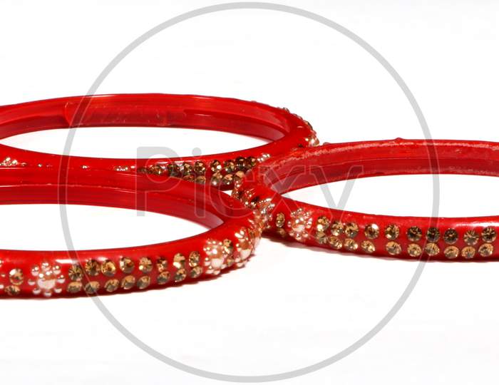 Closeup Of Red Bracelets Decorated With Small Stones Isolated On A White Background